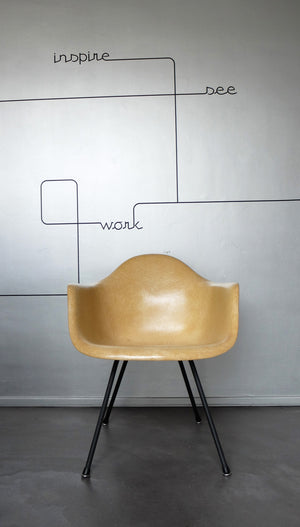 LAX armchair by Charles and Ray Eames in ocher colour