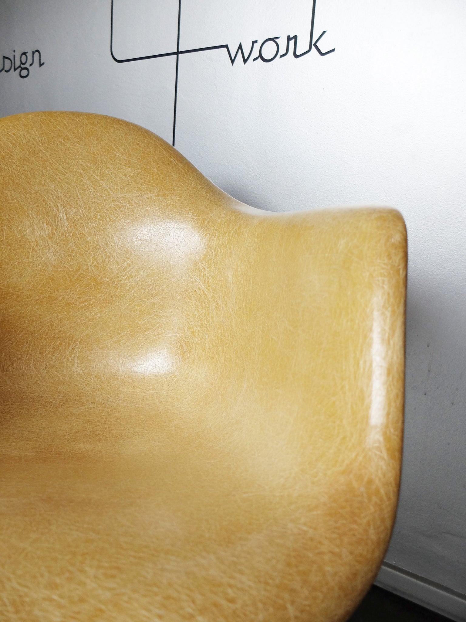 LAX armchair by Charles and Ray Eames in ocher colour